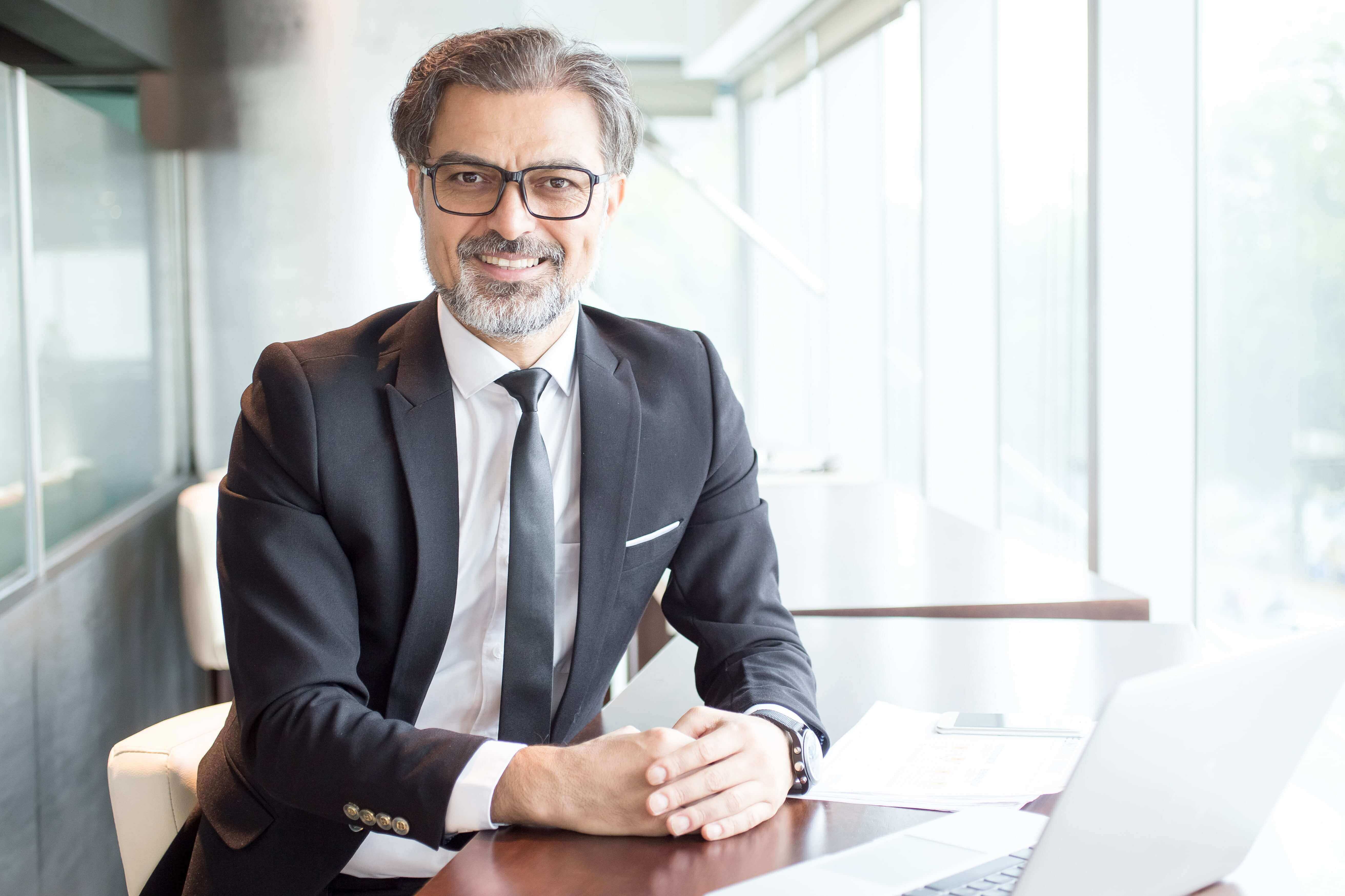 A man in a business suit in an office.